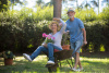 Senior couple playing with a wheelbarrow
